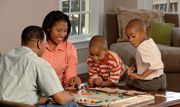 A family playing a game of Monopoly
