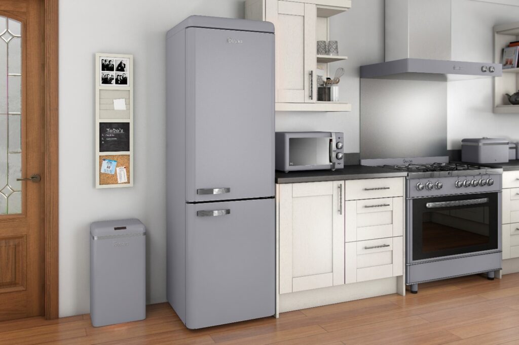 Photograph of Swan grey retro fridge next to a grey retro bin in a fitted kitchen