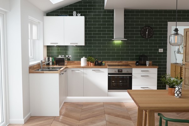 Photograph of a Vogue Slab Kitchen in White with Green wall tiles and wooden countertops and tables from Wren Kitchens