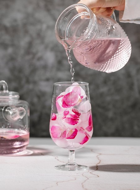 Photograph of watermelon cocktail decorated with edible pink petals