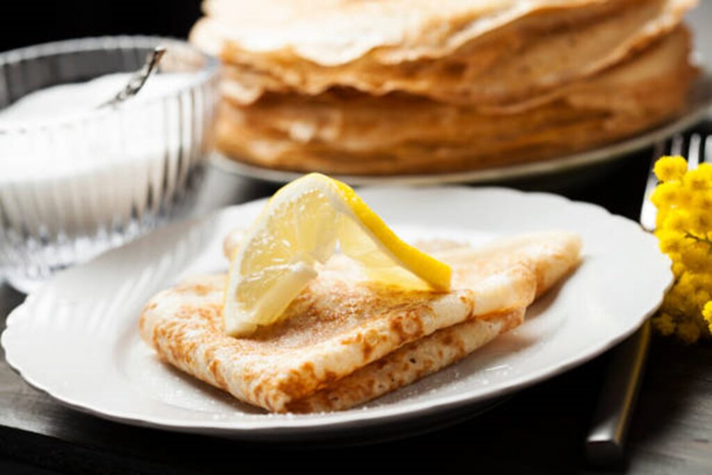 lemon and sugar on top of a folded pancake