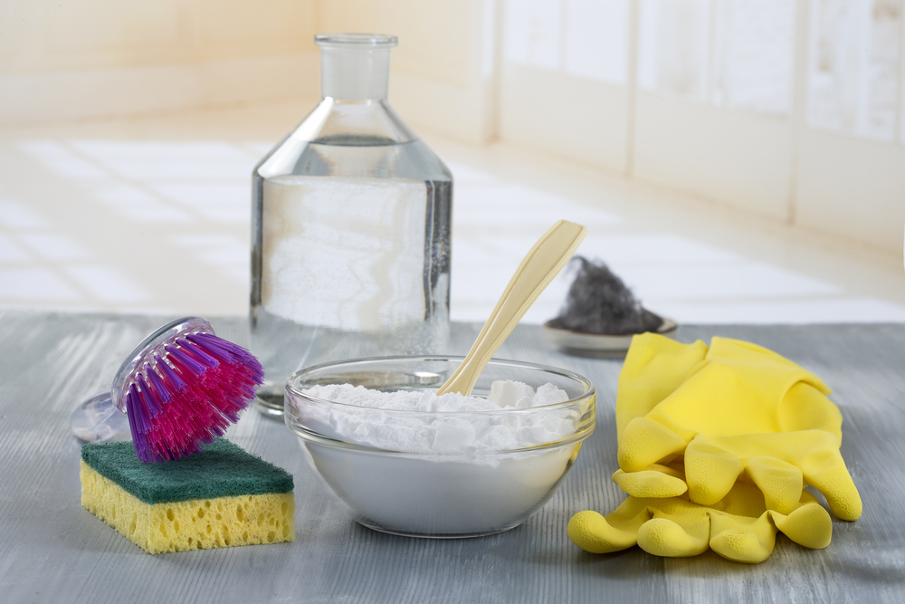 Photograph of a bowl of bicarbonate rubber cleaning gloves and a sponge
