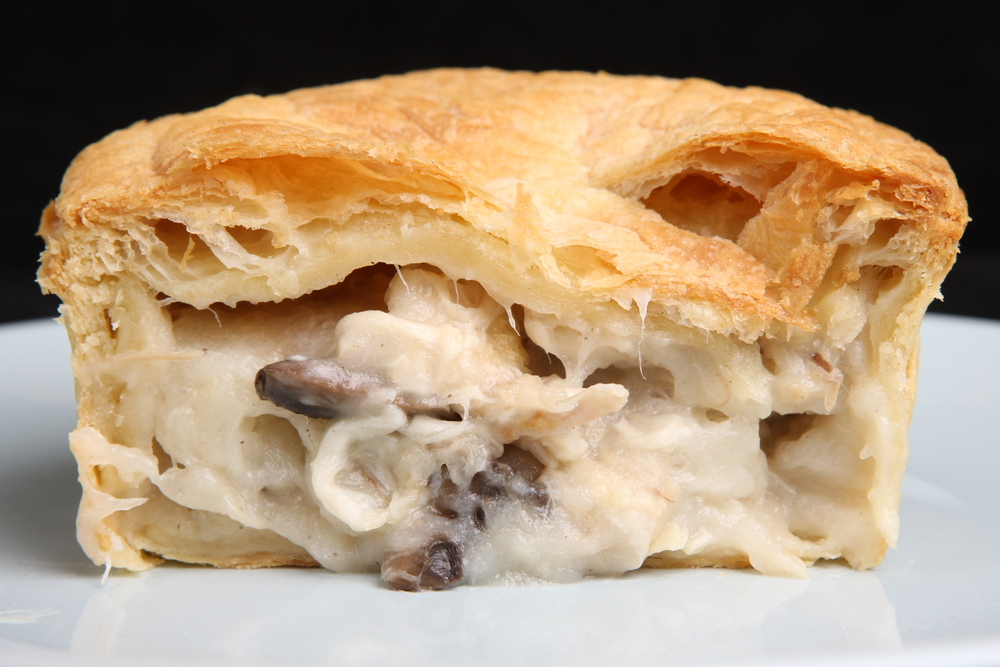 Close up photograph of a  Chicken, kale and mushroom pot pie