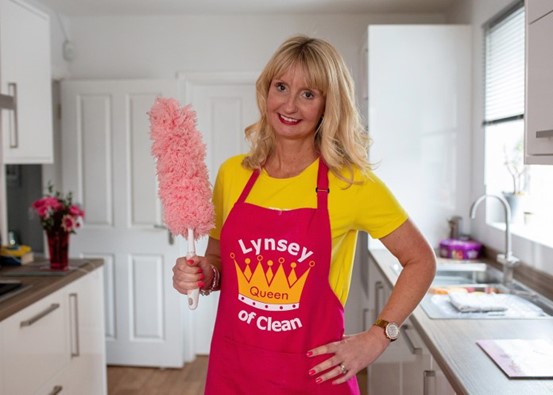 Lynsey crombie in a cooking apron standing in her kitchen