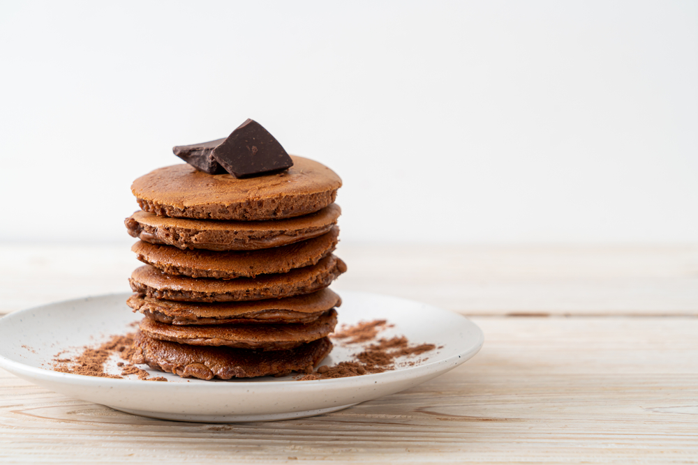 Colour image of fluffy chocolate pancakes stacked on a plate