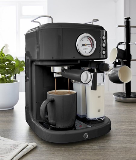 Black Swan Retro One Touch Espresso Machine in a fitted modern kitchen making coffee and frothing milk