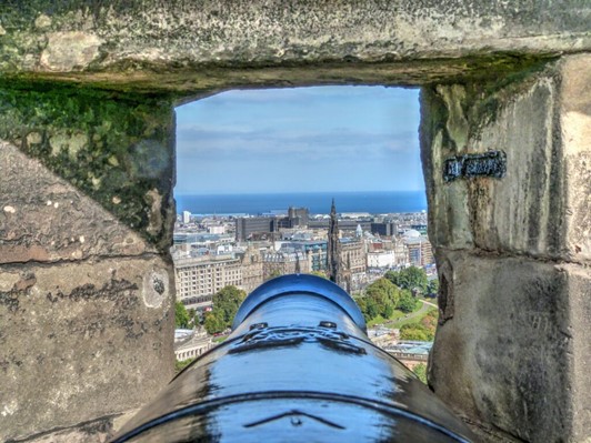 Close-up view of Edinburgh from the view of a canon hole in a Edinburgh castle wall