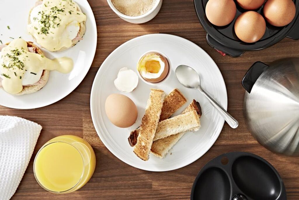 Photograph of dippy eggs and soldiers, poached eggs on muffins and the Swan Egg Boiler