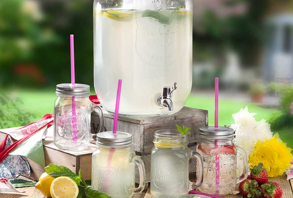 Photograph of Swan Glass Beverage dispenser full of cloudy lemonade with four small glasses nearby