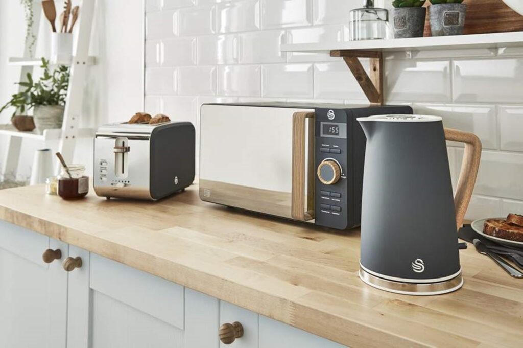 Nordic Slate Grey Kettle, Microwave and Two Slice Toaster in a fitted cream and wood kitchen with white tiles