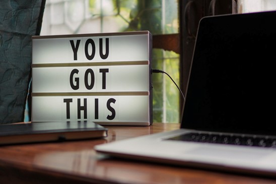 Tile light box on a wooden desk next to a laptop and diary with the words "You Got This" on it