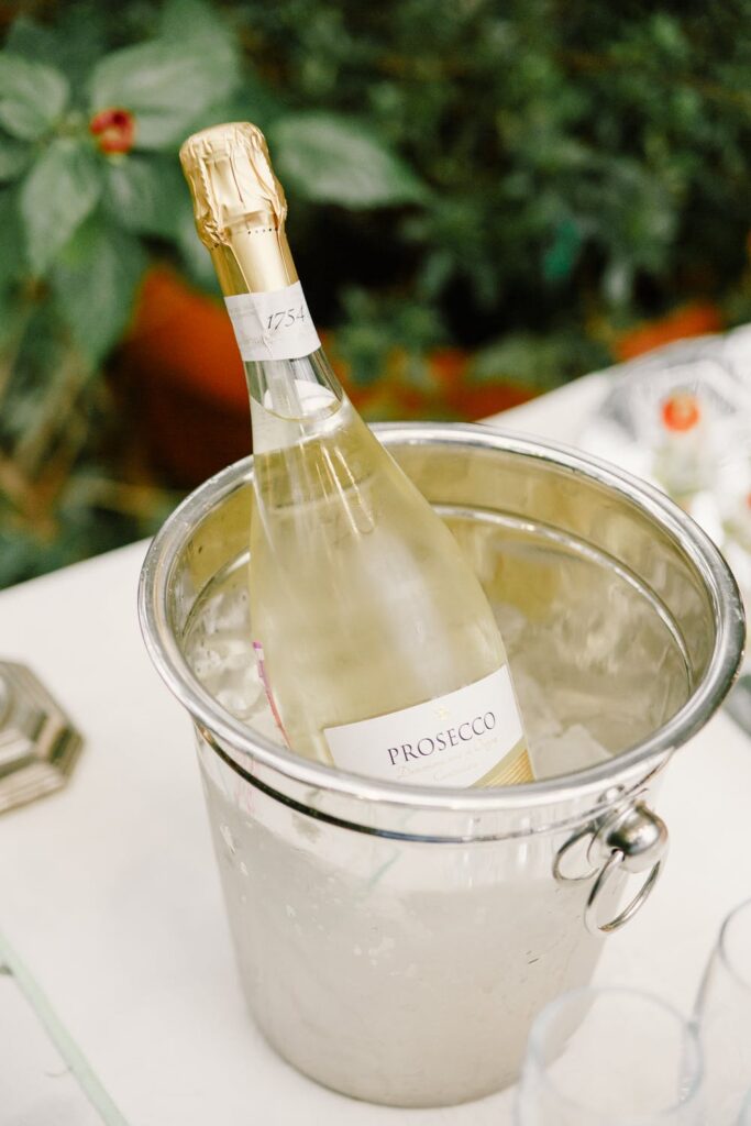 A bottle of prosecco in an ice bucket. 