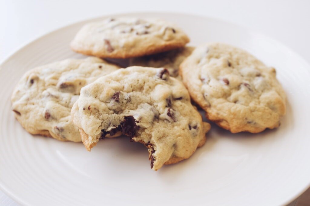 A selection of chocolate chip cookies on a white plate. 
