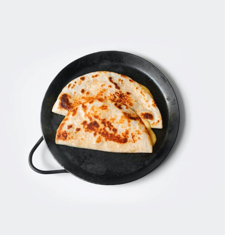 A set of tortillas toasting in a pan