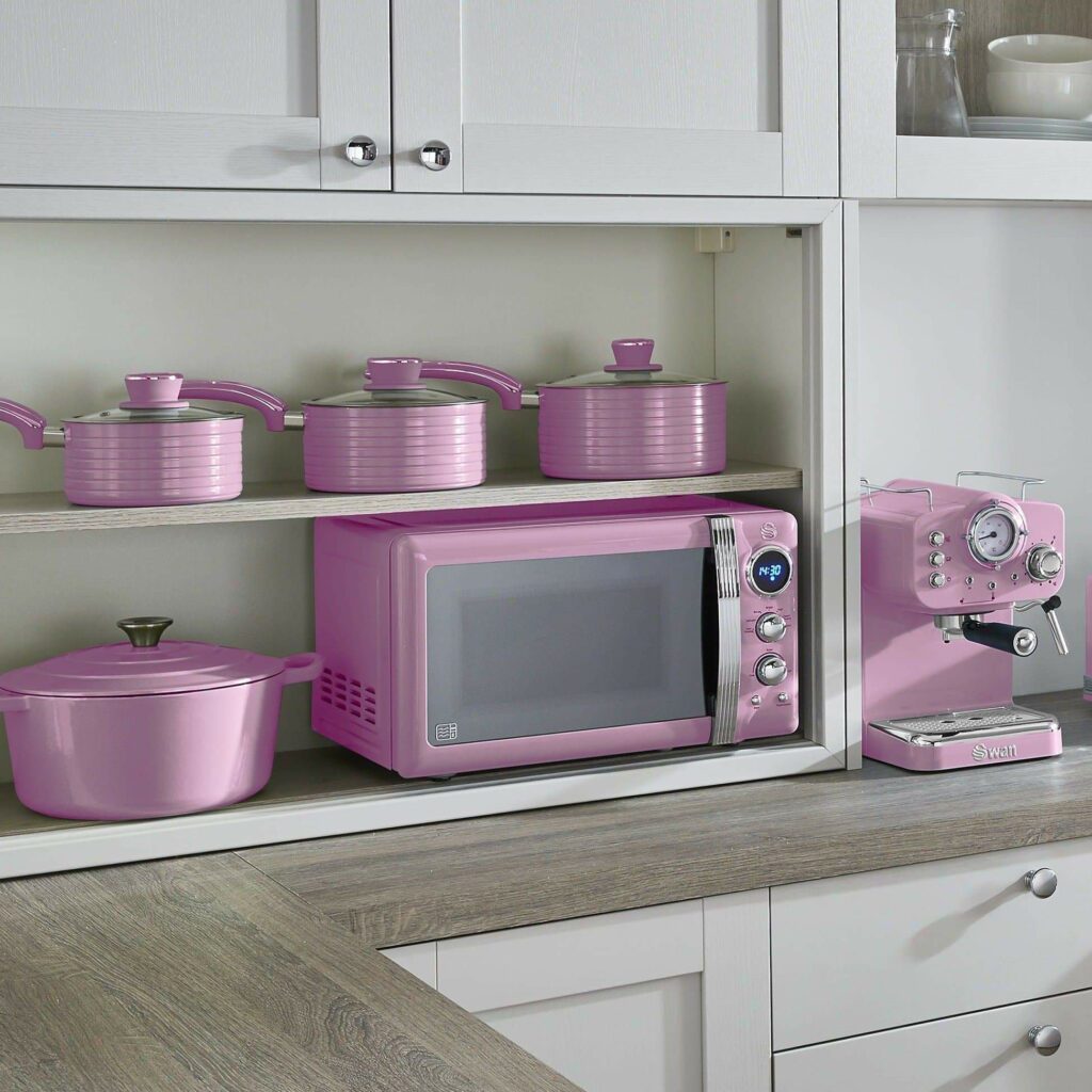 White and ash grey kitchen fitted with retro pink appliances including the retro pink microwave, retro 4 piece pan set and retro one touch espresso machine
