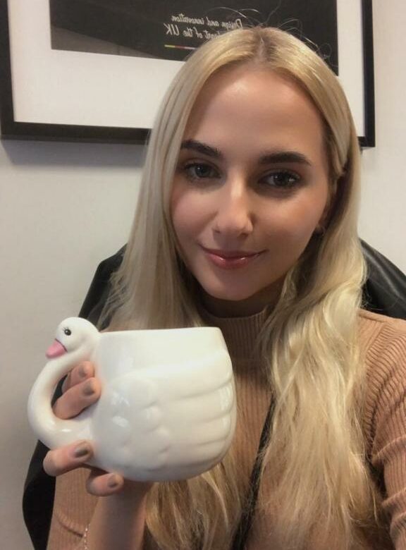 Selfie of marketing executive meda holding the Swan ceramic mug