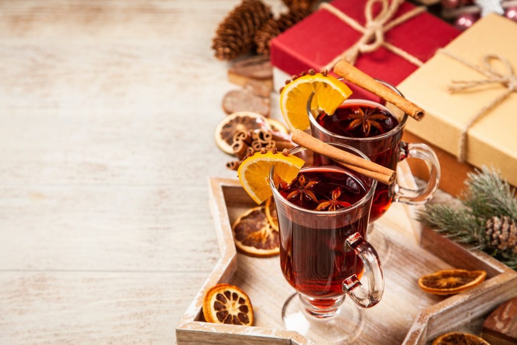 A wooden table with two glasses of mulled wine. 