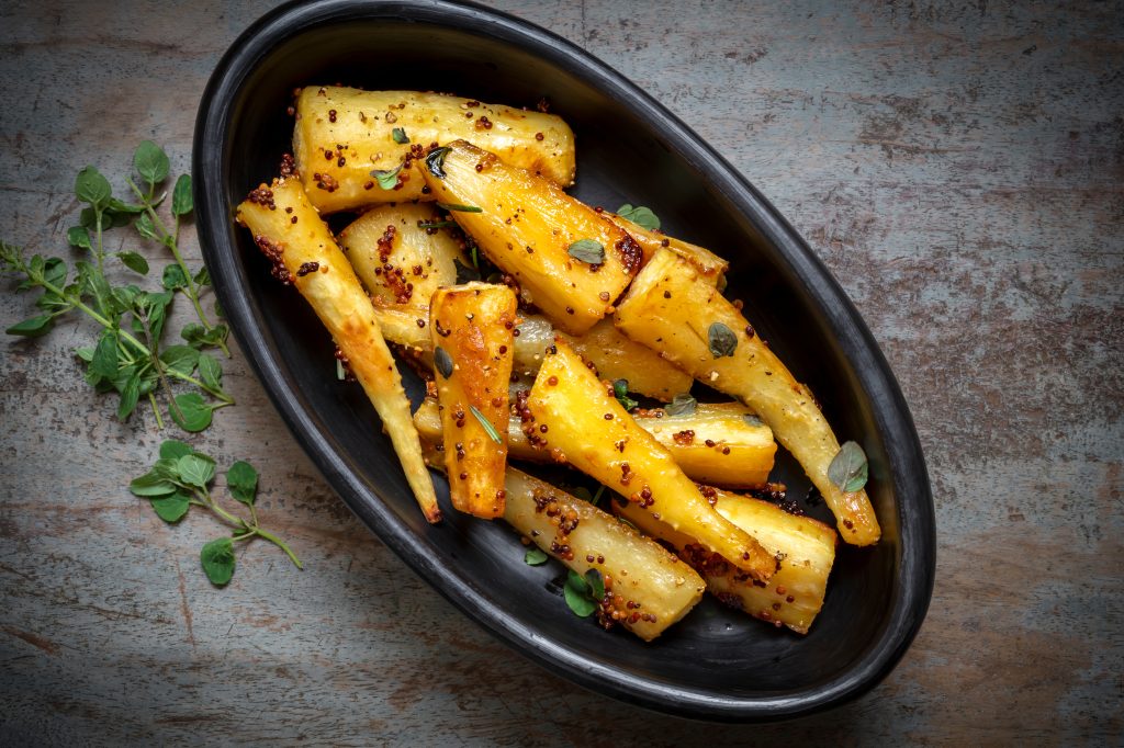 Dish of roasted parsnips with wholegrain mustard and honey,