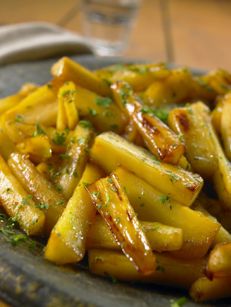 Honey roasted parsnips with a sprinkling of herbs.