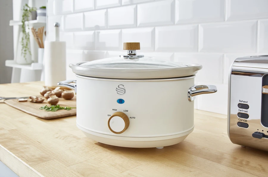 Image of the Swan Nordic Slow cooker in white on a kitchen countertop. 