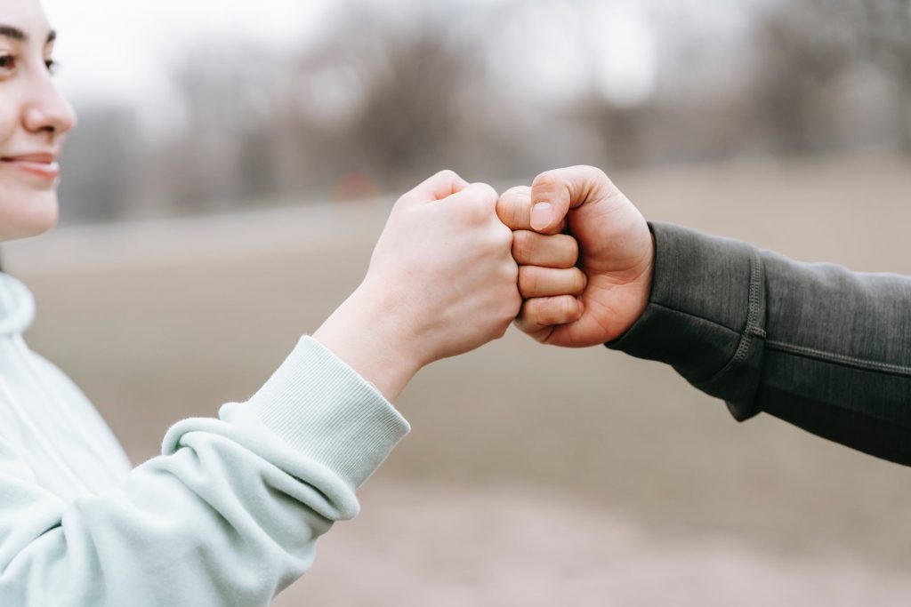 Two people fist bumping.