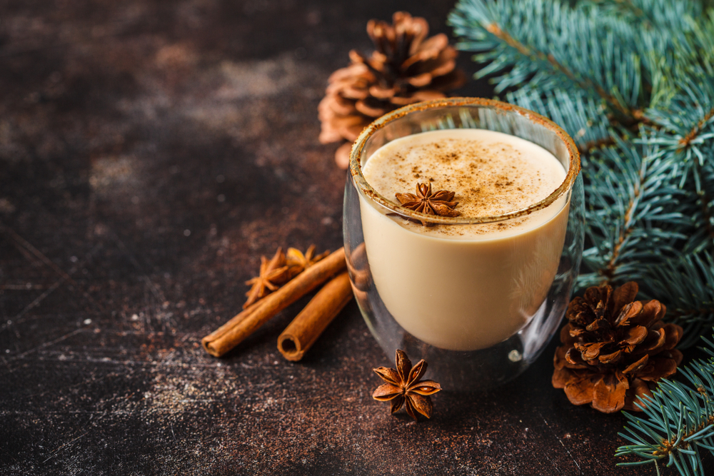 Eggnog in a double walled coffee cup on a christmas dinner recipes blog.