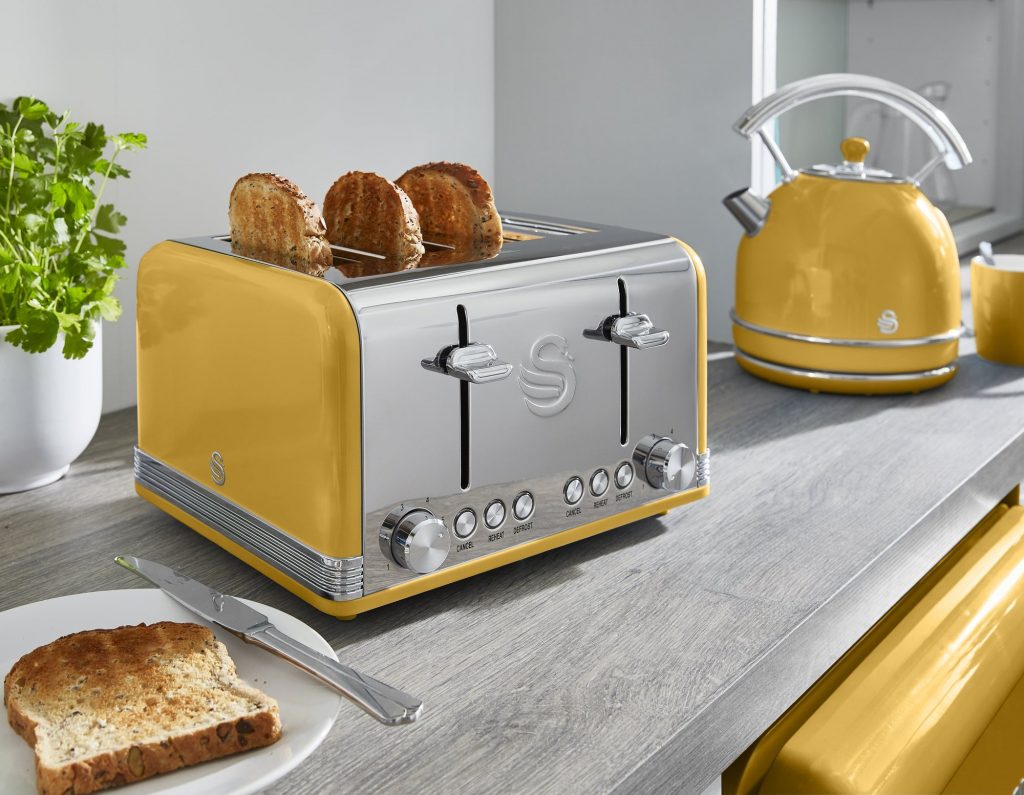 Retro Mellow Yellow 4 slice toaster with the Retro Dome Kettle in the background in a modern kitchen, matching pantone's colour of the year