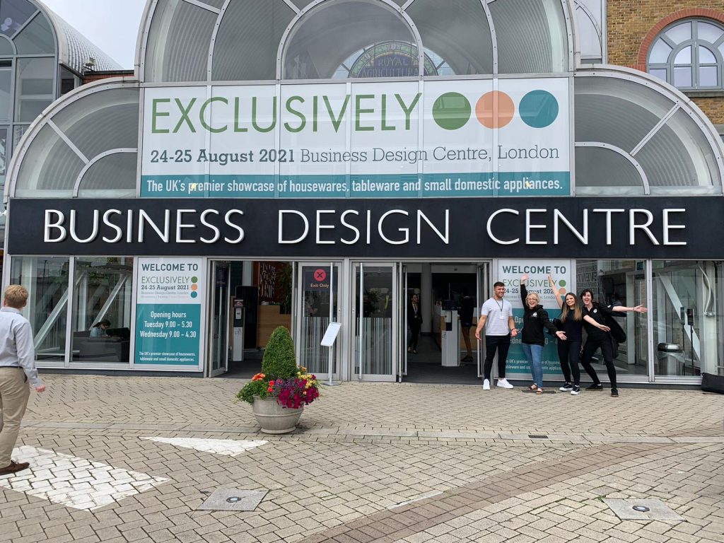 Outdoor view of the Exclusively Housewares event venue in London with a black banner reading "Business Design Centre"