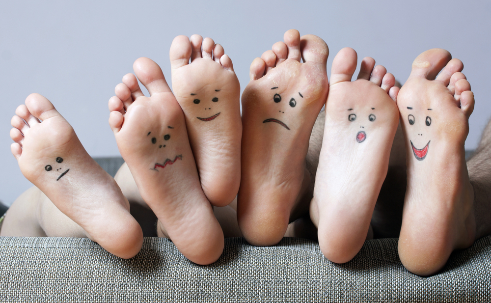 Three sets of feet have smiley and sad faces drawn on the soles for blog about healthy lifestyle changes.