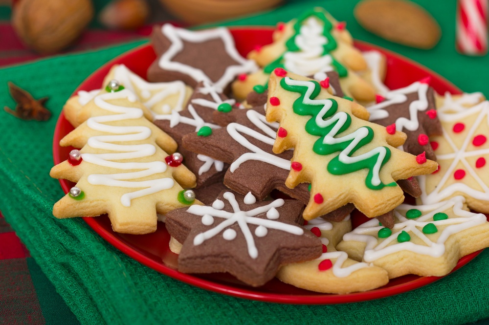 Colour image of christmas tree and star cookies on a red plate