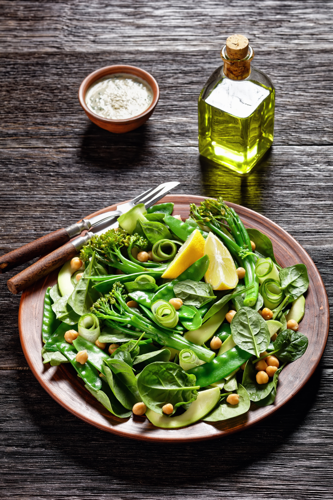 Bright green mangetout salad in wood bowl for mangetout recipes blog.
