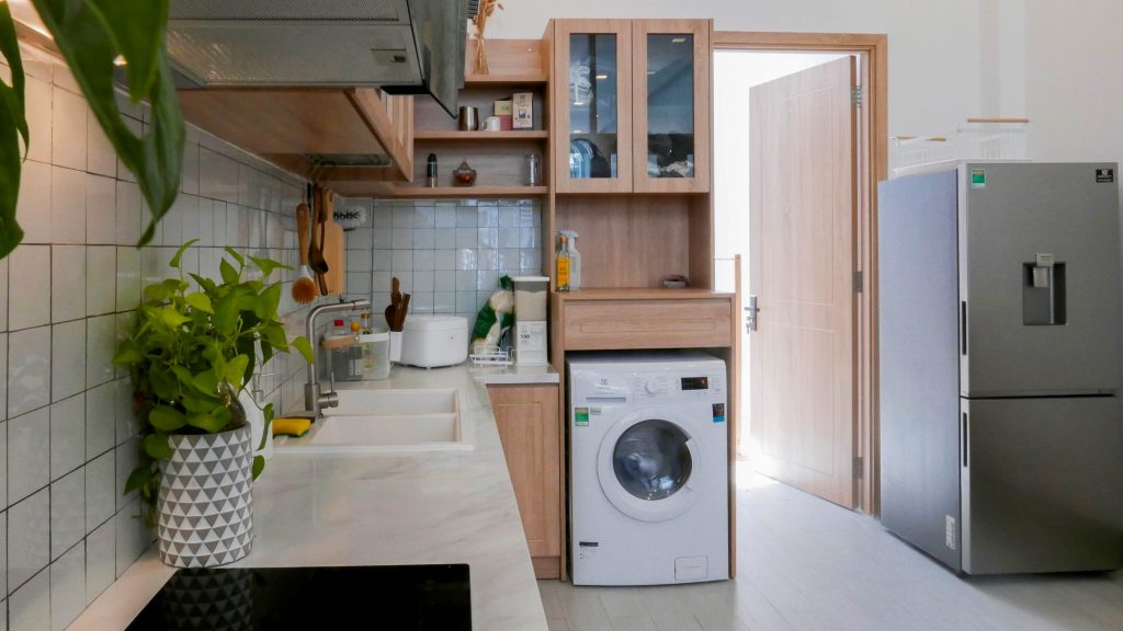 Kitchen showing toaster, refrigerator and washing machine appliances.